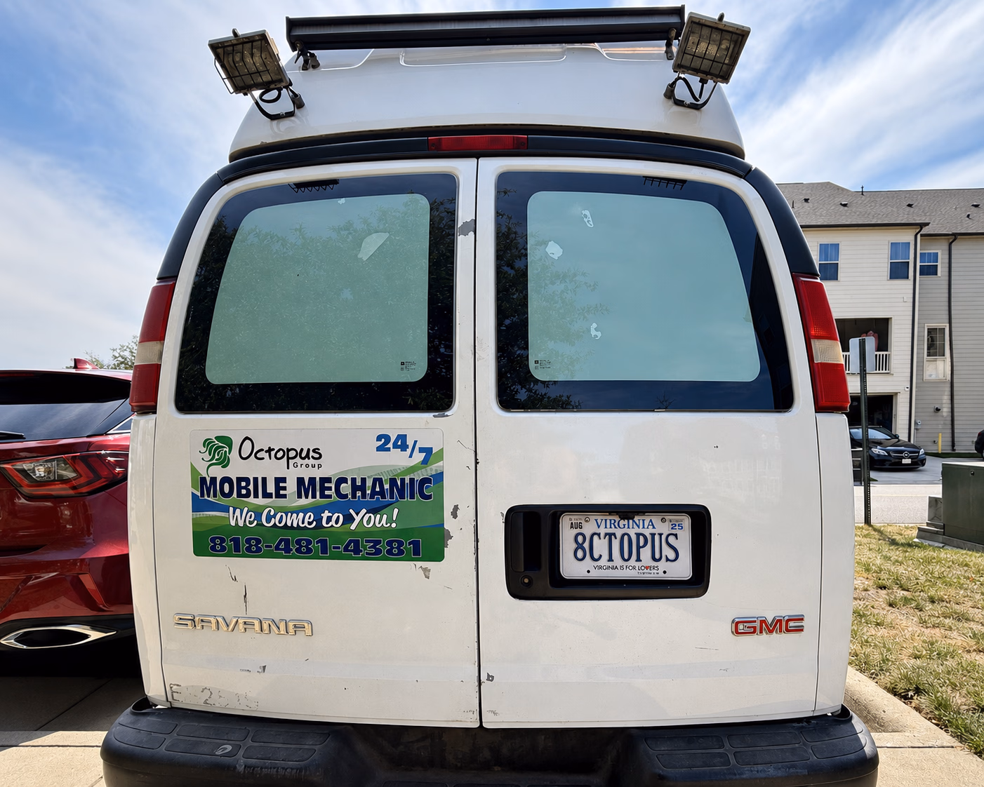 White GMC Savana van with Octopus Group mobile mechanic sign and Virginia license plate 8CTOPUS.